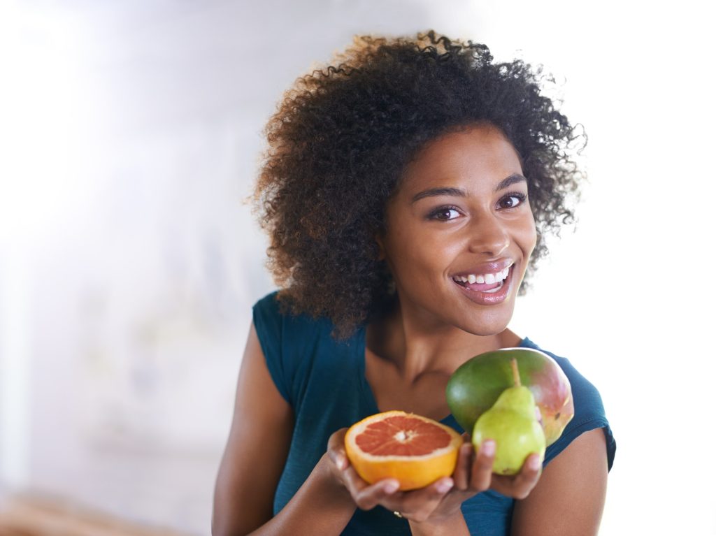 Top view shot of a beautiful young woman offering you a selection of fresh produce